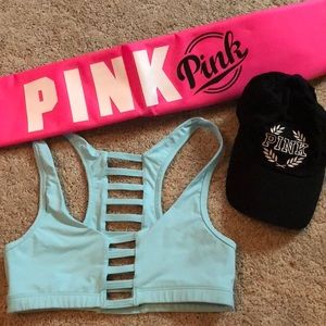 Pink VS sports bra, cooler, and baseball cap